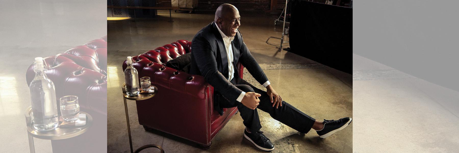 Magic Johnson seated in chair for interview