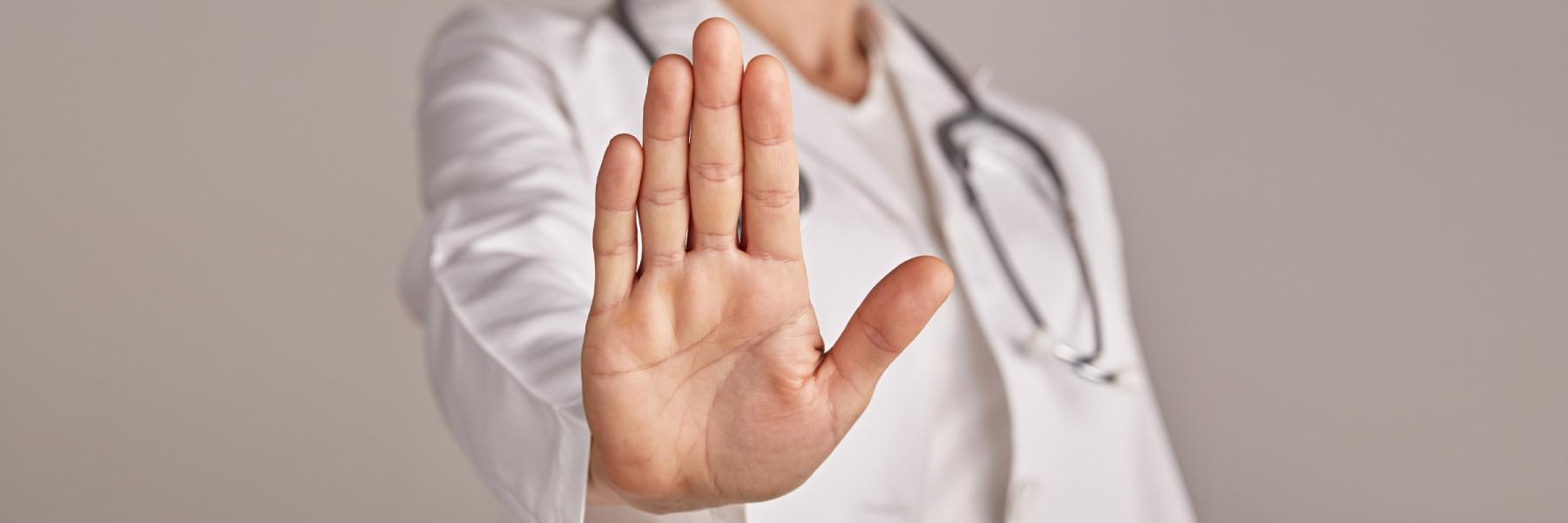 image of a doctor with their hand help in front, as if to say stop, representing stigma