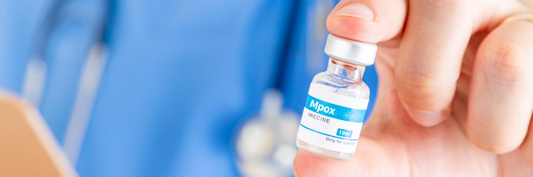 closeup of a vial of mpox vaccine, being held by a doctor