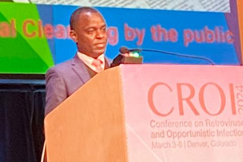 photo of Uganda gay rights activist Dr. Frank Mugashi speaking at the CROI medical conference